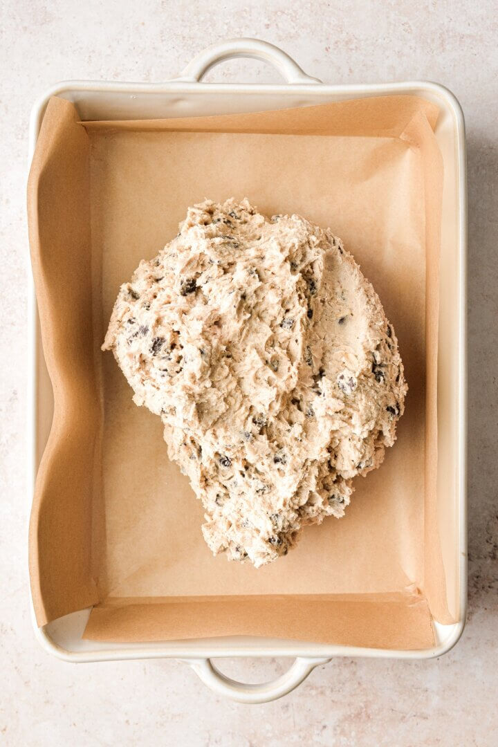 Oatmeal chocolate chip cookie dough in a baking pan.
