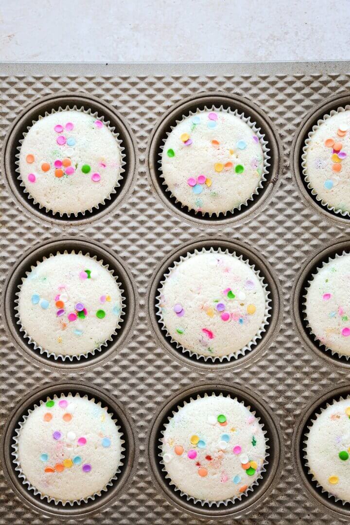 Funfetti cupcakes in a muffin pan.