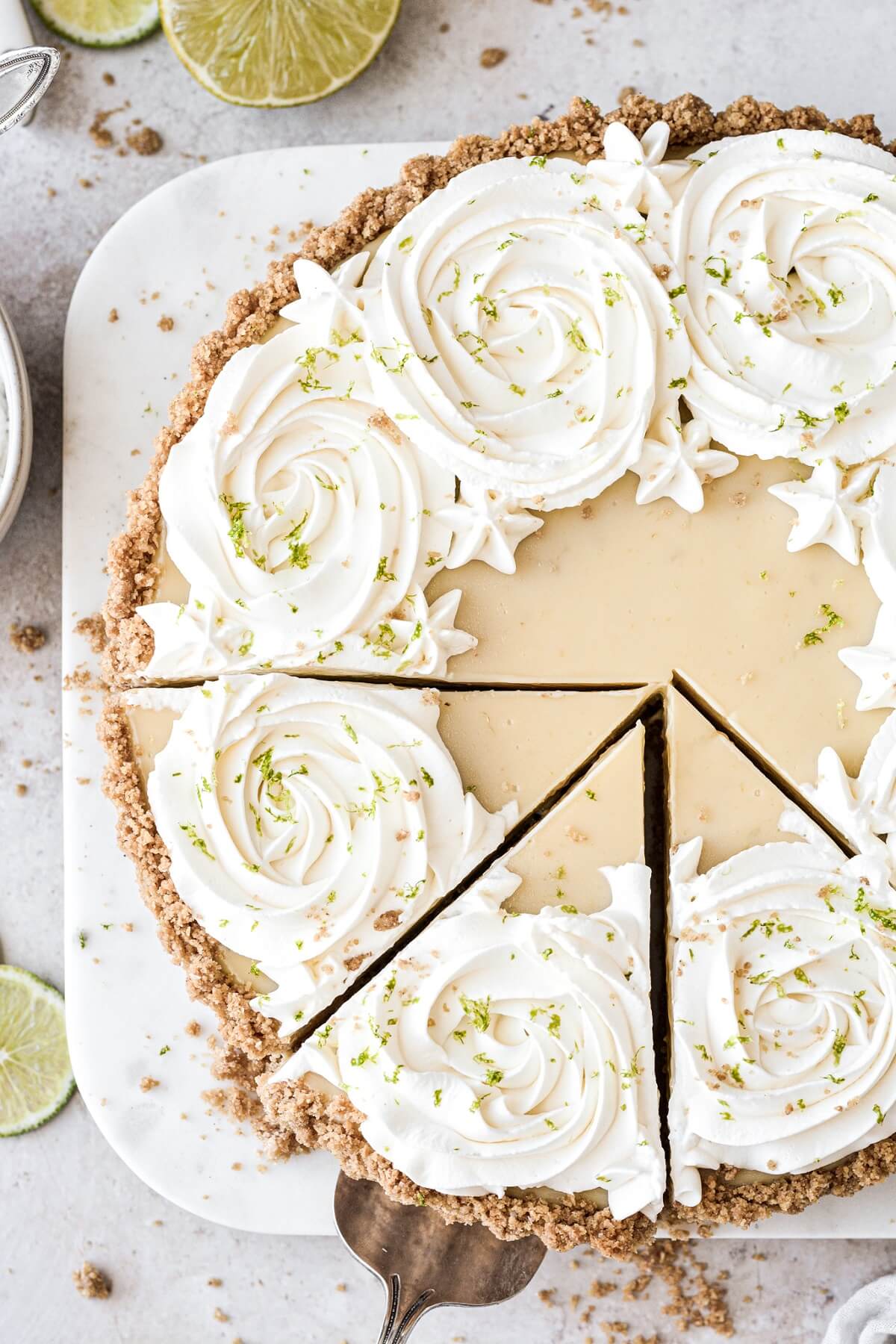 A key lime pie cut into slices.