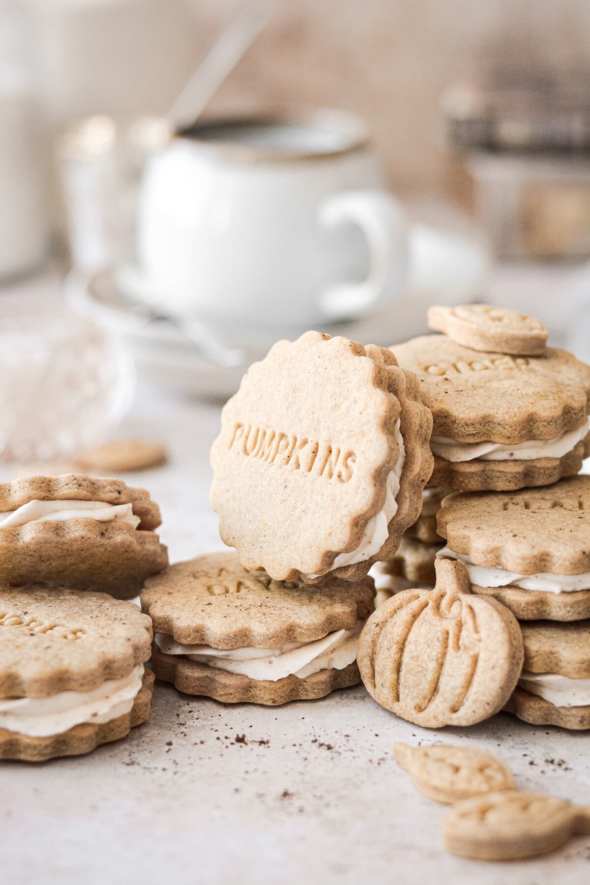 Pumpkin spice shortbread cookie sandwiches filled with buttercream.