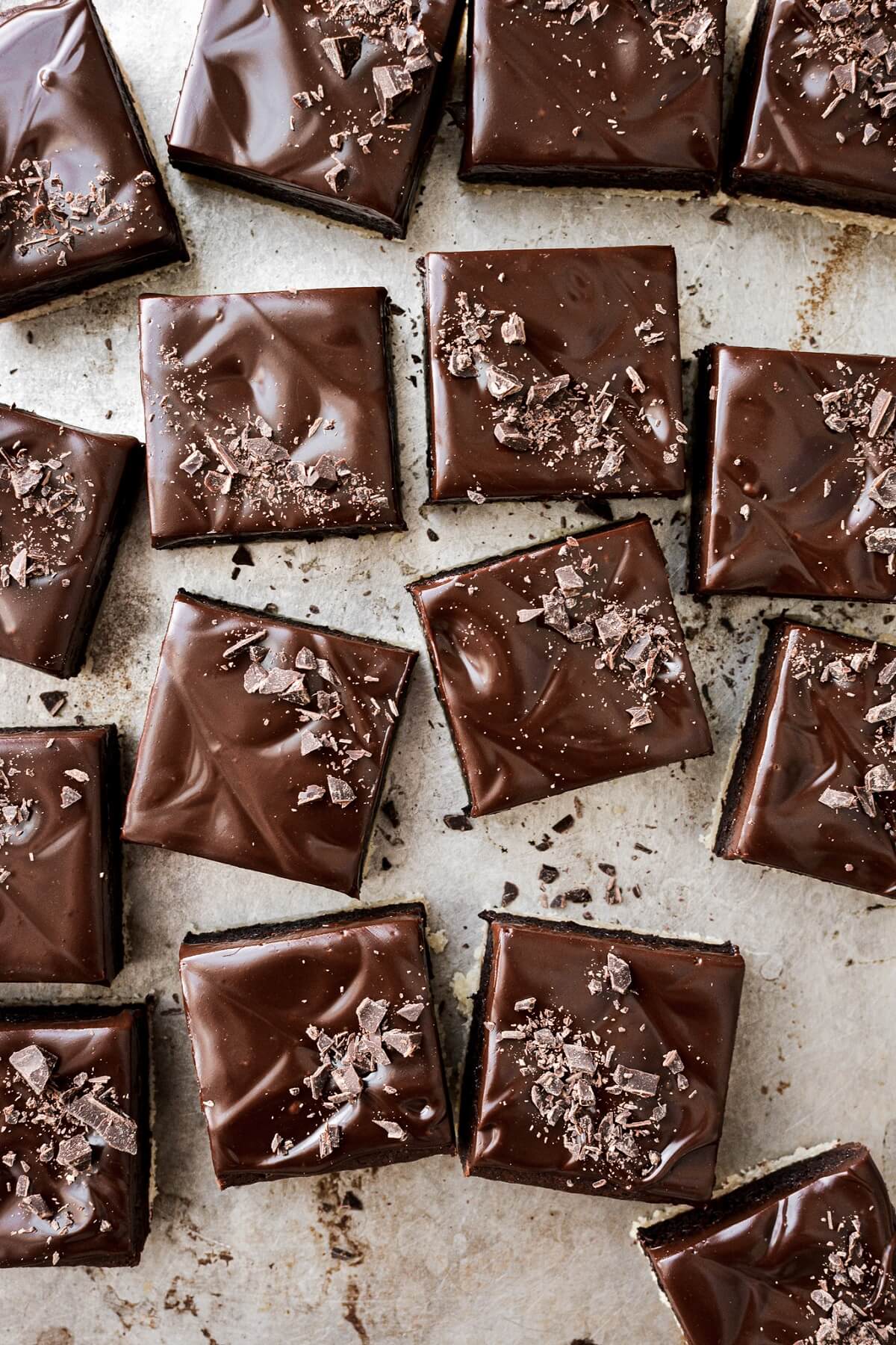Shortbread brownies topped with ganache and chopped chocolate.