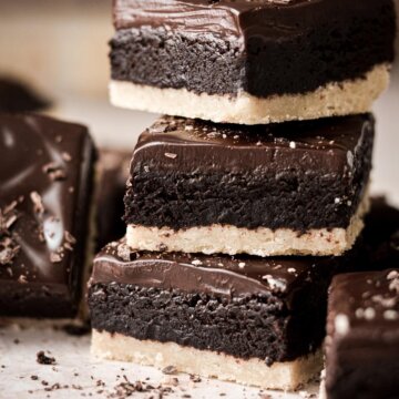 A stack of shortbread brownies with ganache.