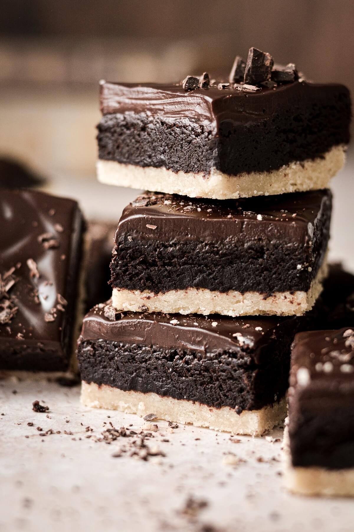 A stack of shortbread brownies with ganache.