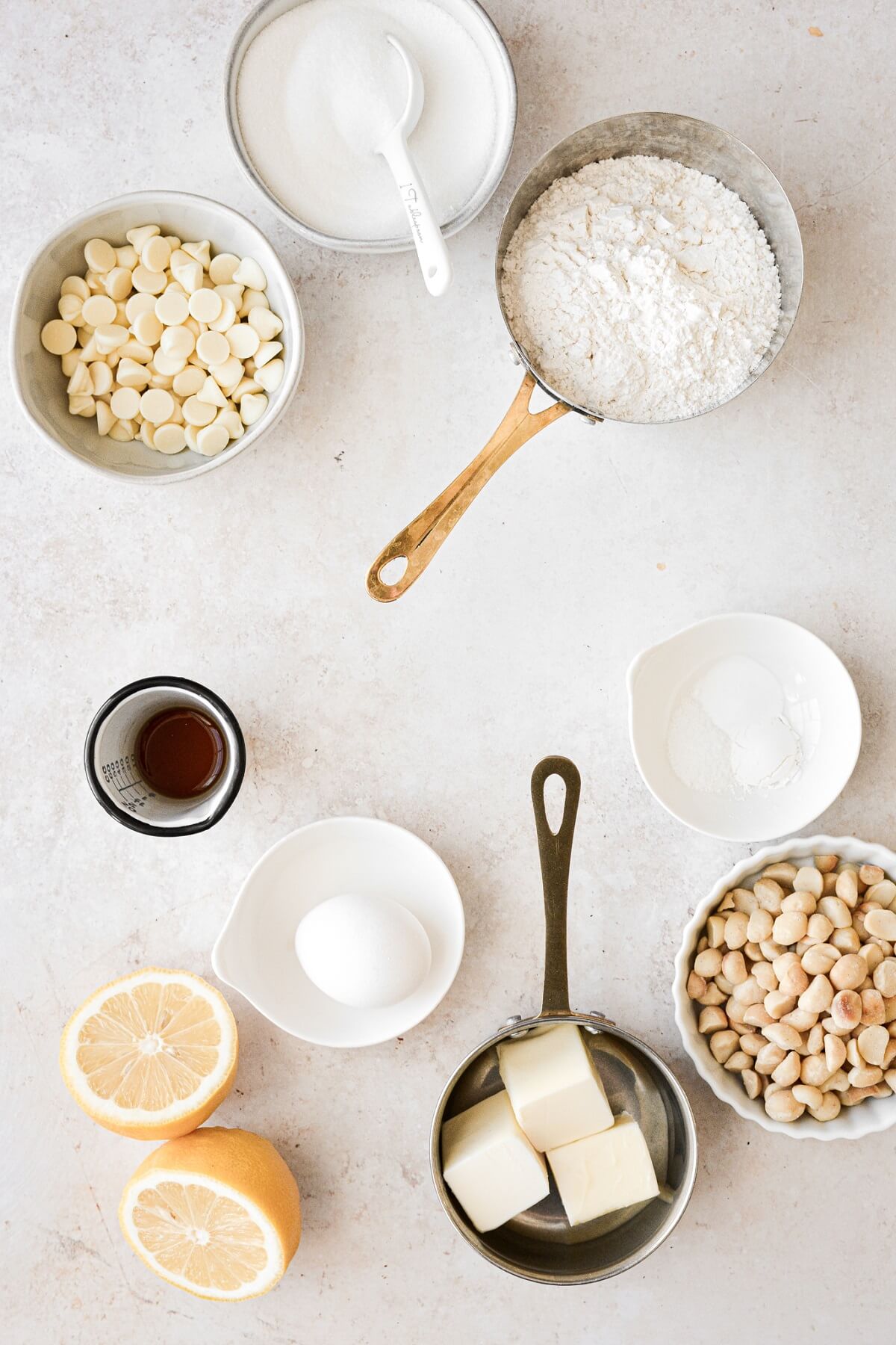 Ingredients for making soft lemon cookies with macadamia nuts and white chocolate chips.