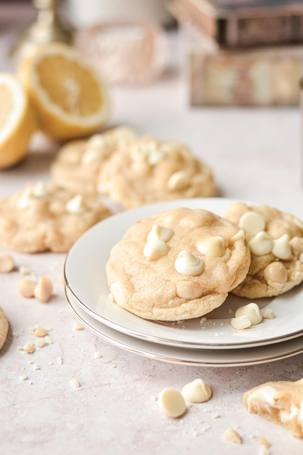 Plate of soft lemon cookies with white chocolate chips and macadamia nuts.