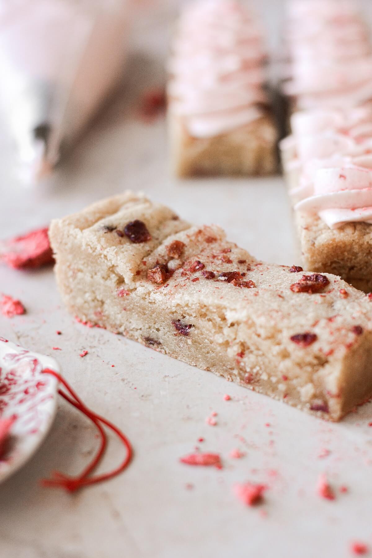 A strawberry blondie sprinkled with freeze dried strawberries.