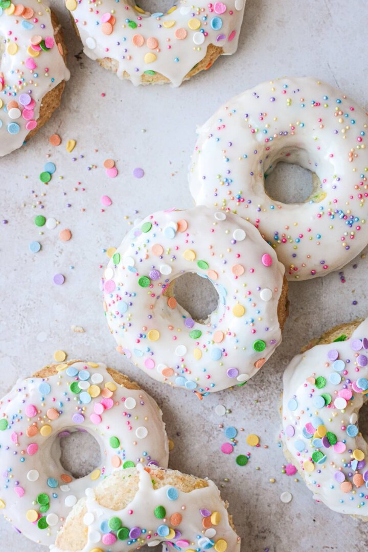 Baked Funfetti cake doughnuts with vanilla icing and sprinkles.