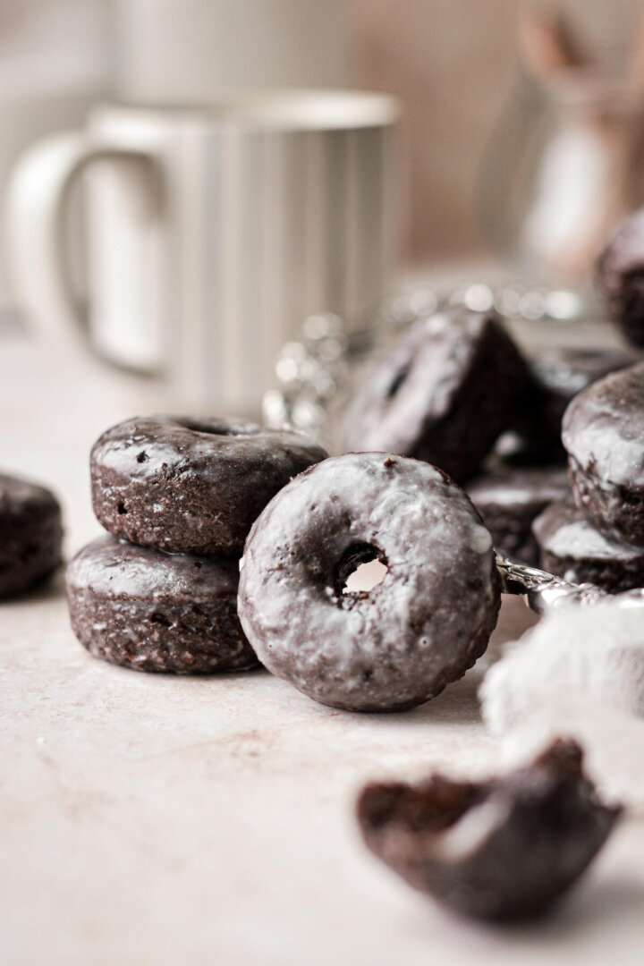Mini baked chocolate cake doughnuts with a cup of coffee.