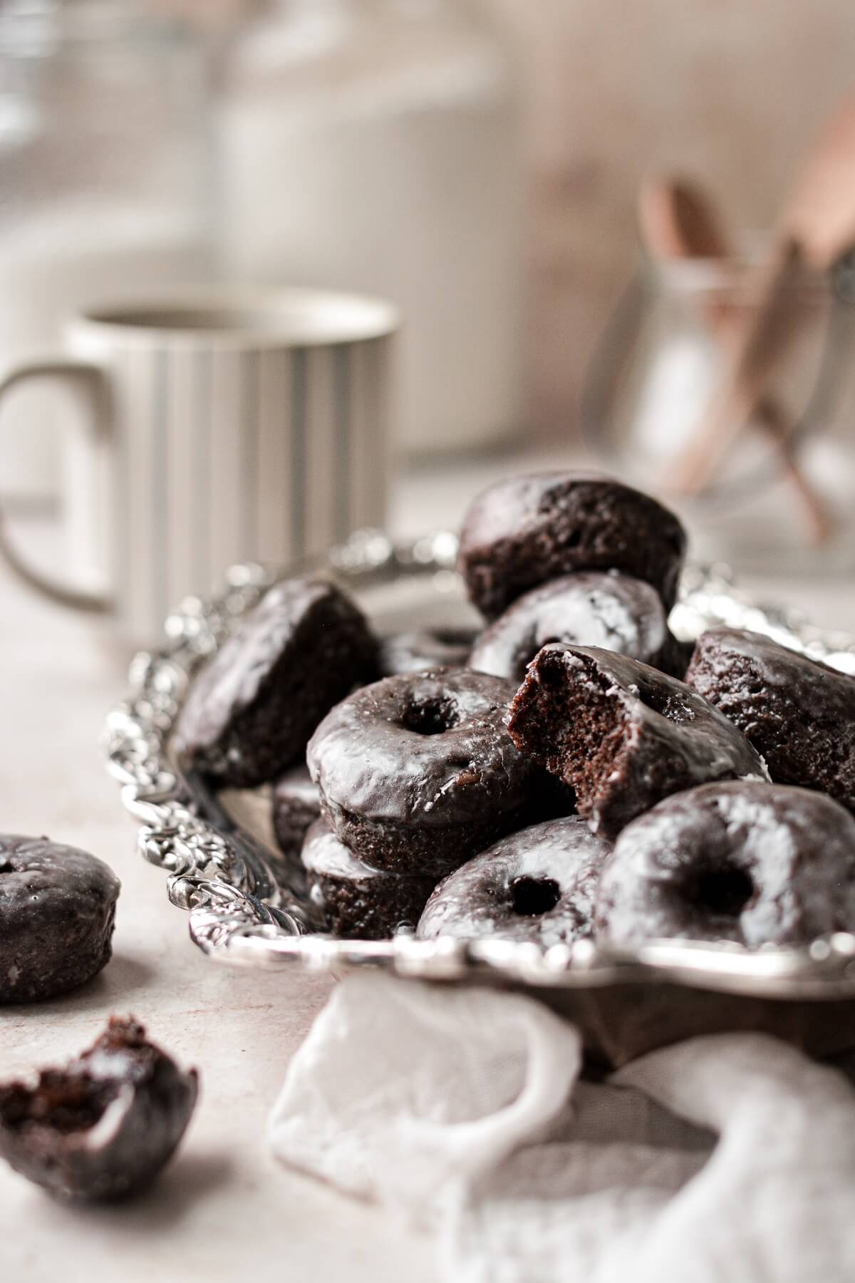 Baked chocolate cake doughnuts on a silver plate.