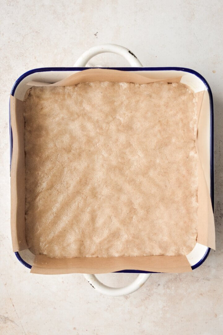 Dough pressed into a baking dish.