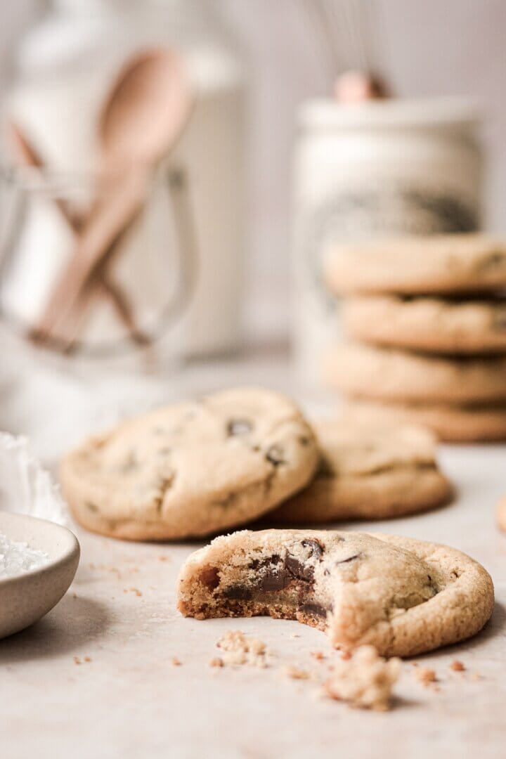 A brown butter rye chocolate chip cookie with a bite taken.