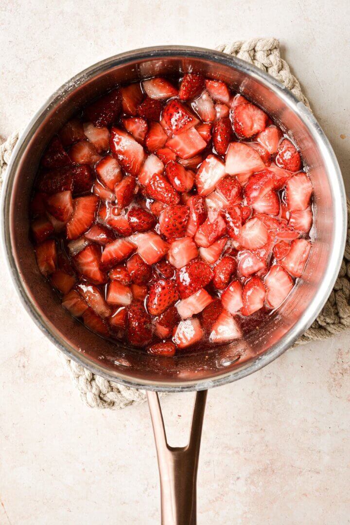 Strawberries simmered in a saucepan.
