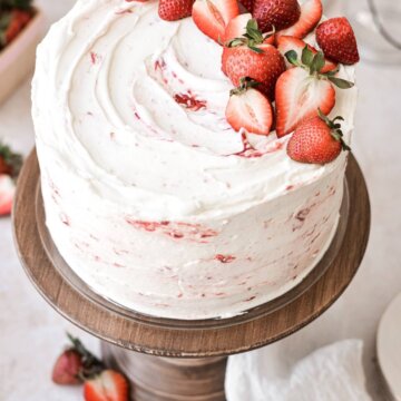 Strawberry shortcake cake topped with strawberries.