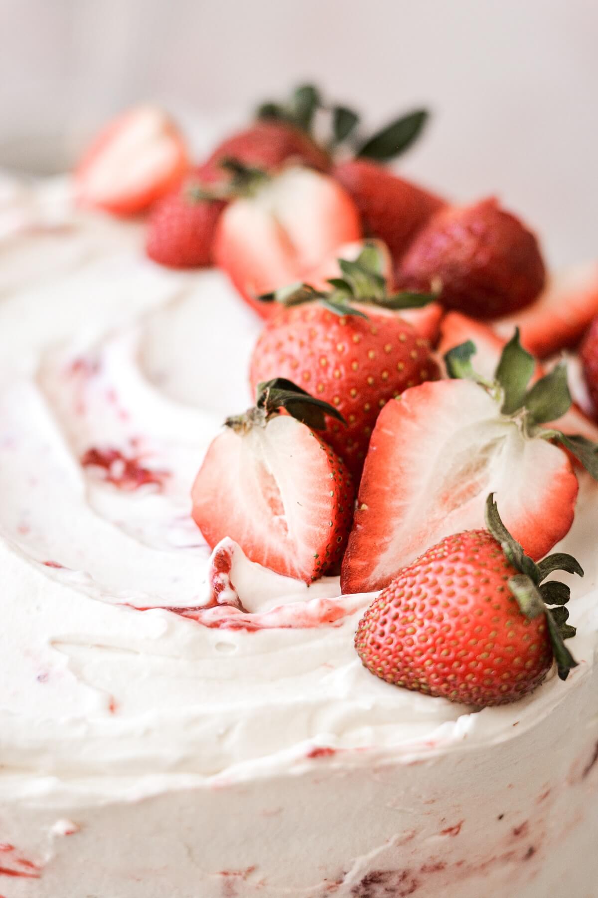 Fresh strawberries on a strawberry shortcake cake.