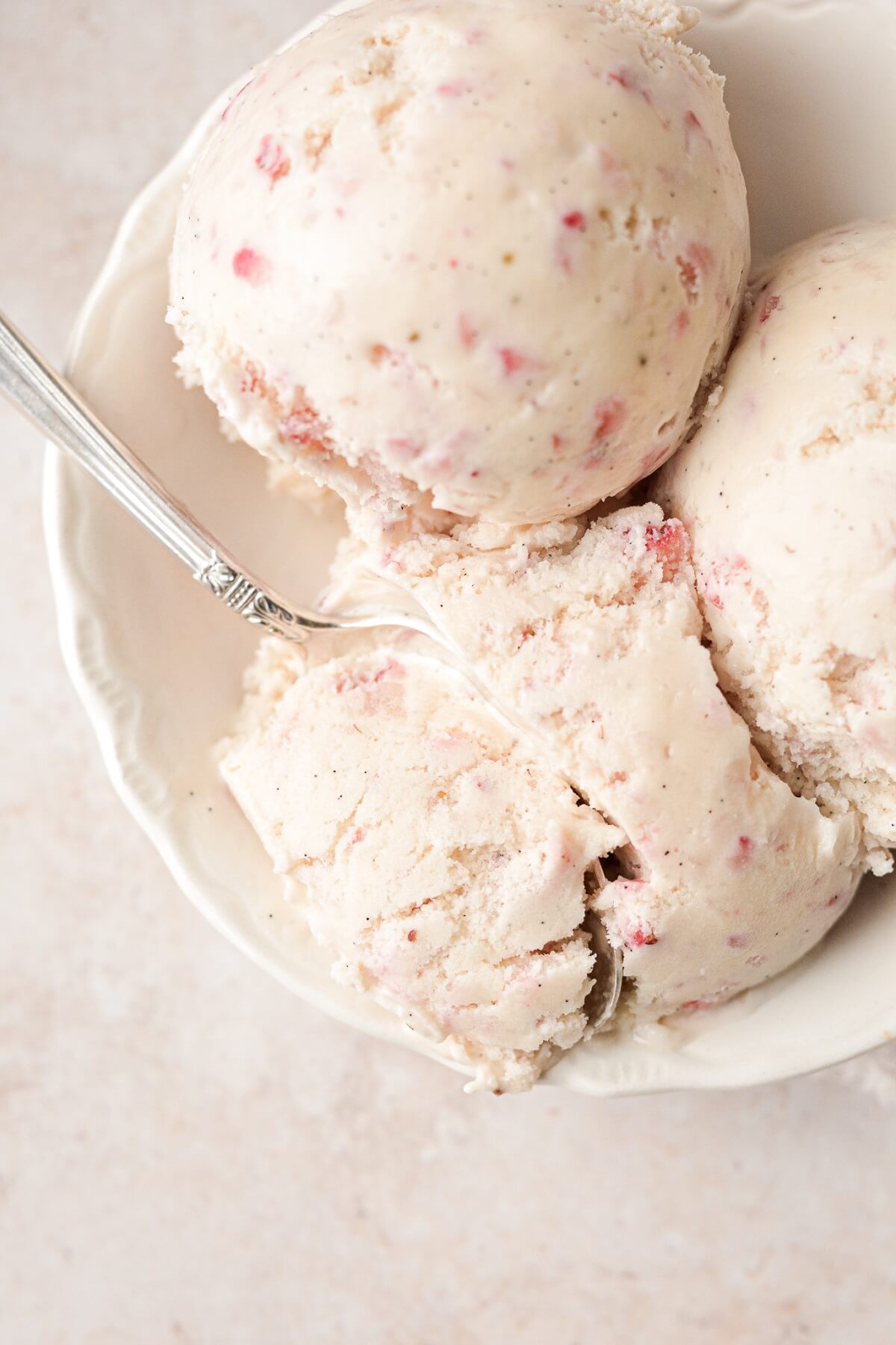 Scoops of strawberry vanilla bean ice cream.