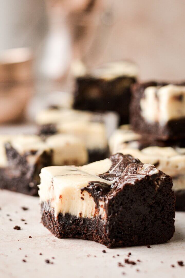 A cream cheese swirl brownie with a bite taken.