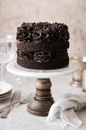 Mini two layer chocolate cake with ruffled chocolate buttercream.