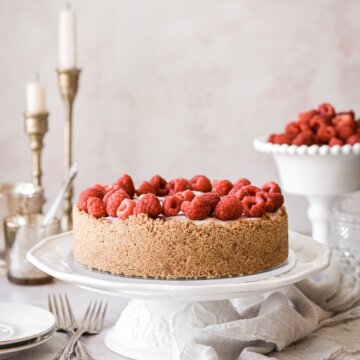No bake raspberry swirl cheesecake topped with raspberries.