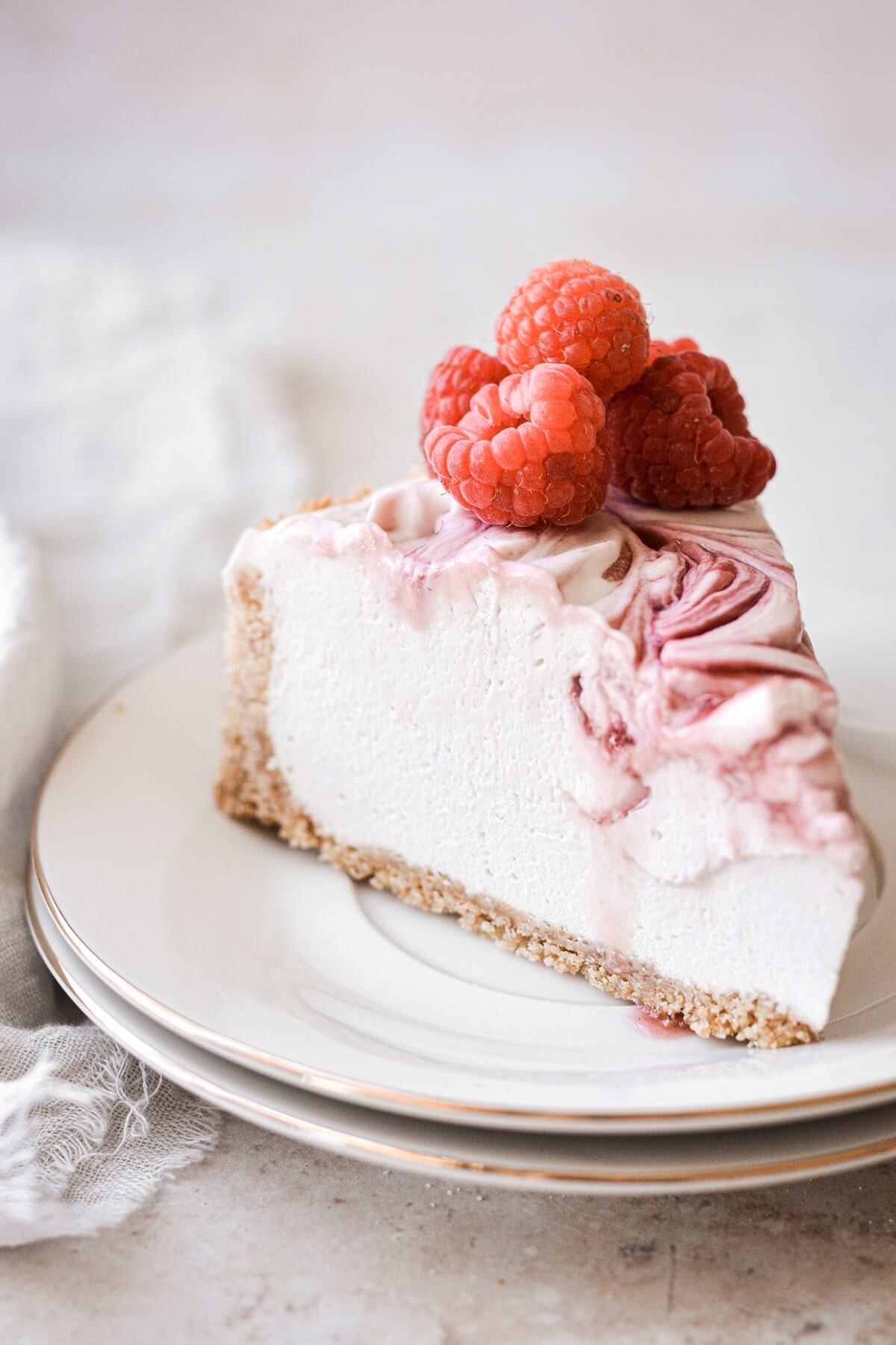 Slice of no bake raspberry swirl cheesecake.