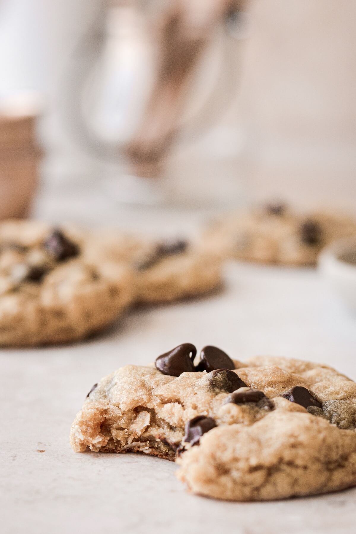 Oatmeal chocolate chip cookies with a bite taken.
