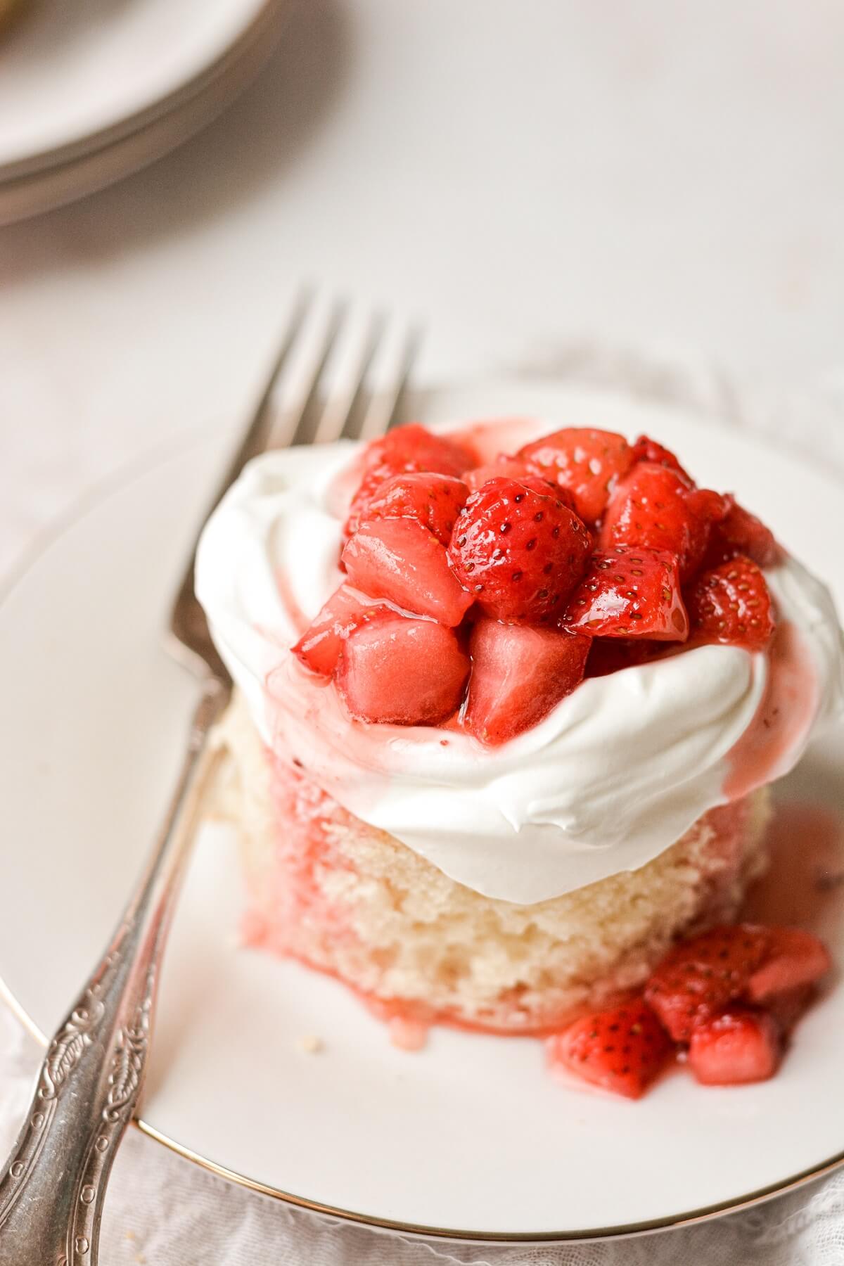 A mini strawberry shortcake on a plate.