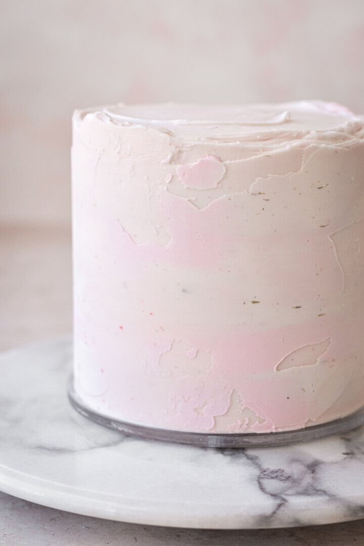 A cake with tetured watercolor buttercream.