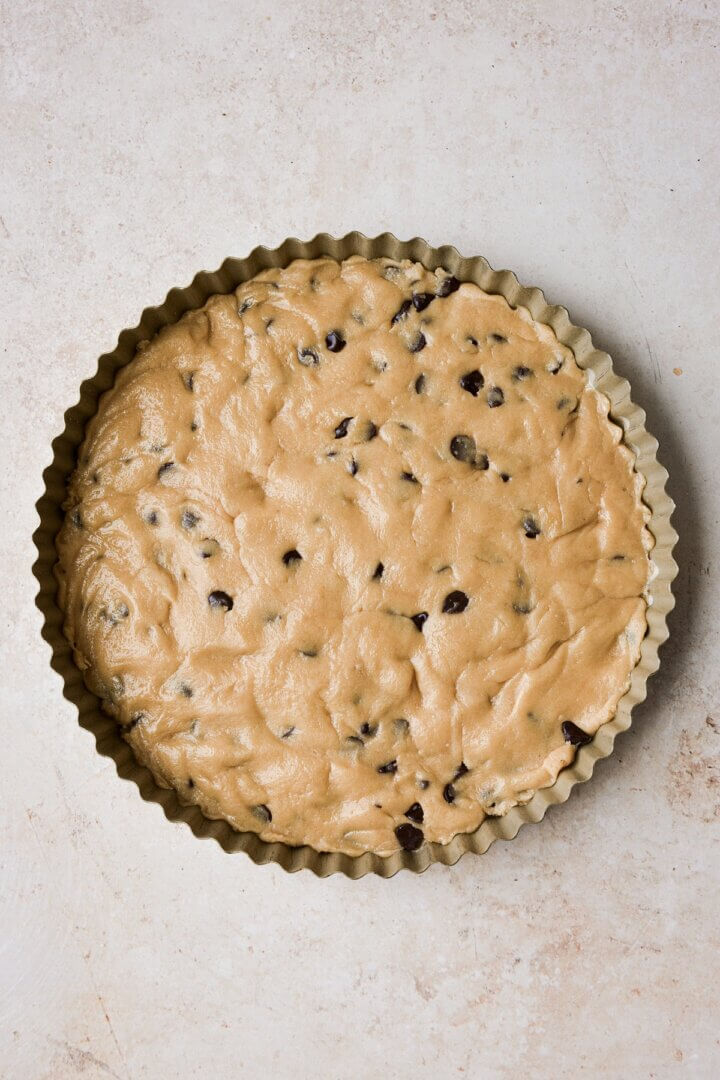 Step 9 for making a big chocolate chip cookie birthday cake.