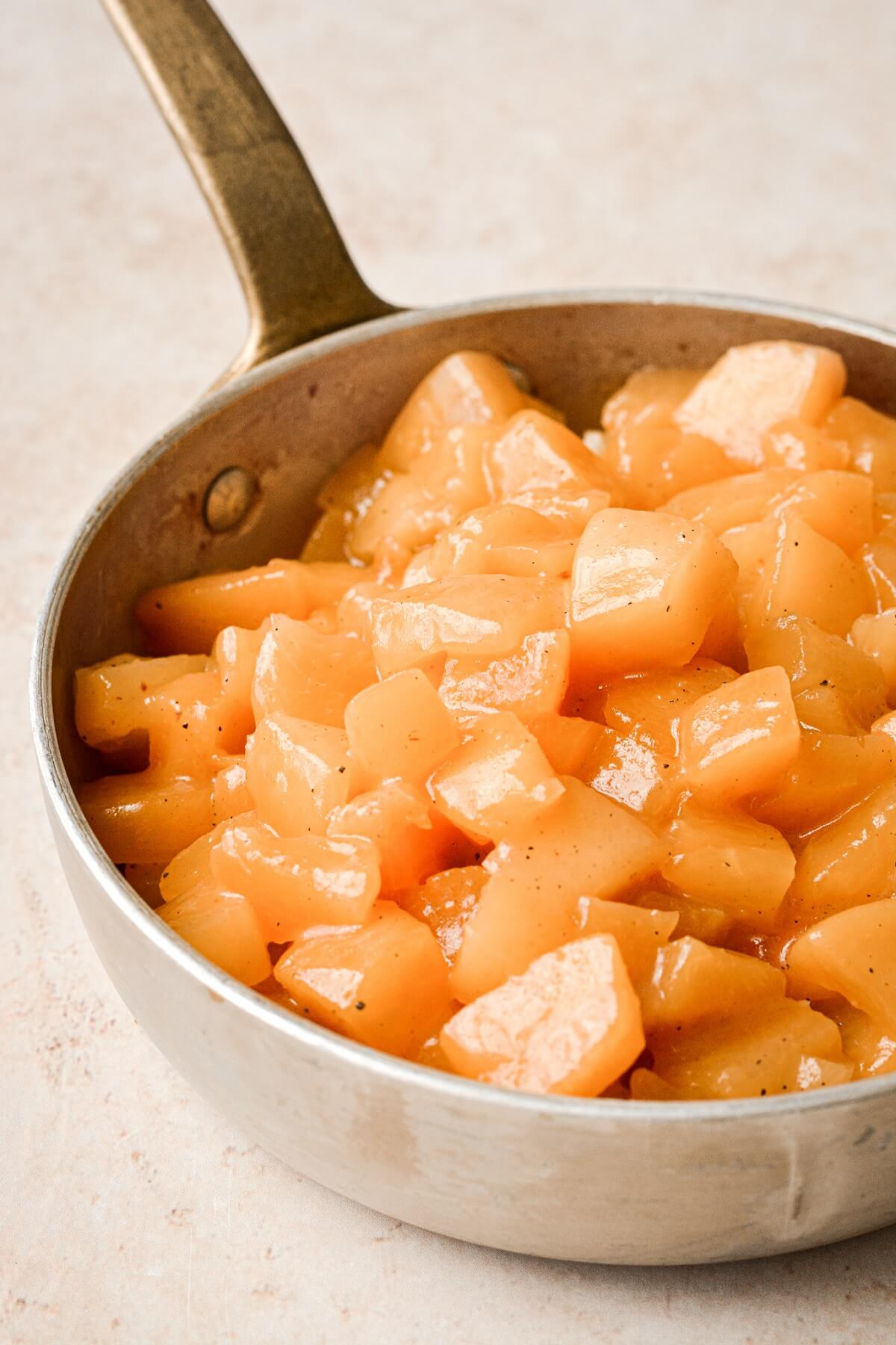 Peach compote in a saucepan.