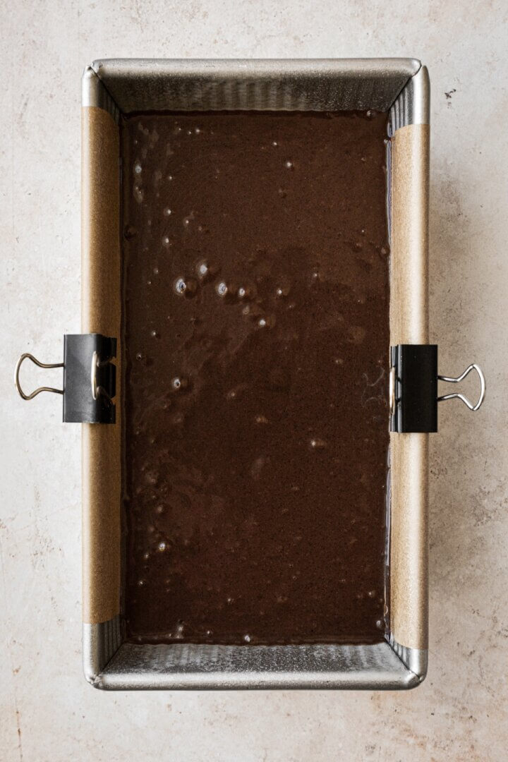 Chocolate cake batter in a loaf pan.