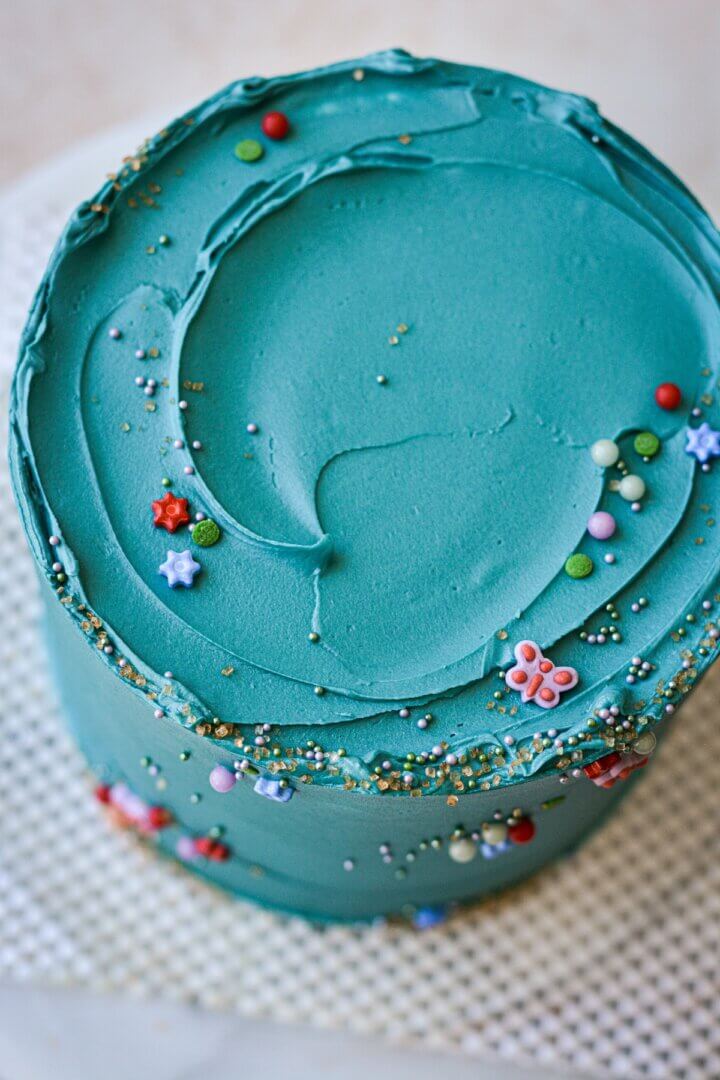 Cake with turquoise buttercream and sprinkles.