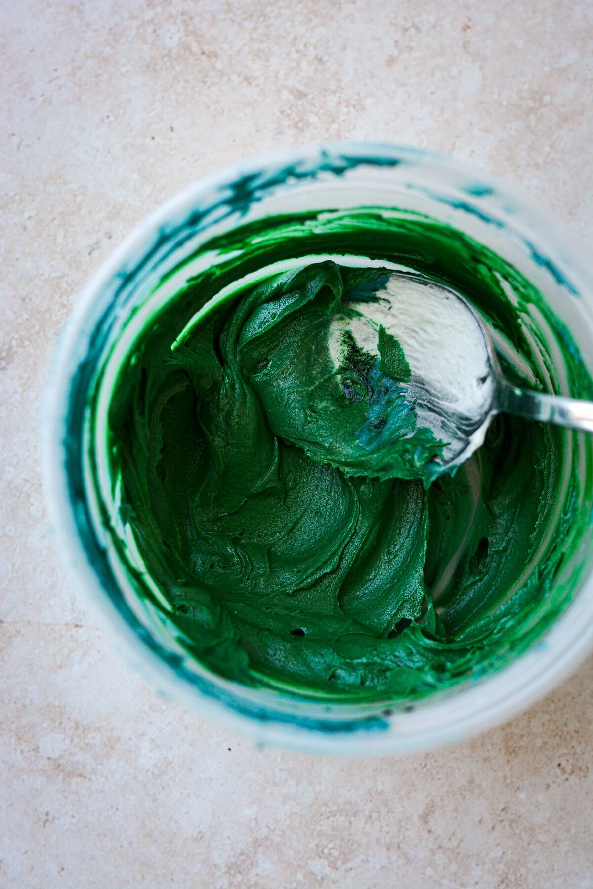 Bowl of dark green buttercream.