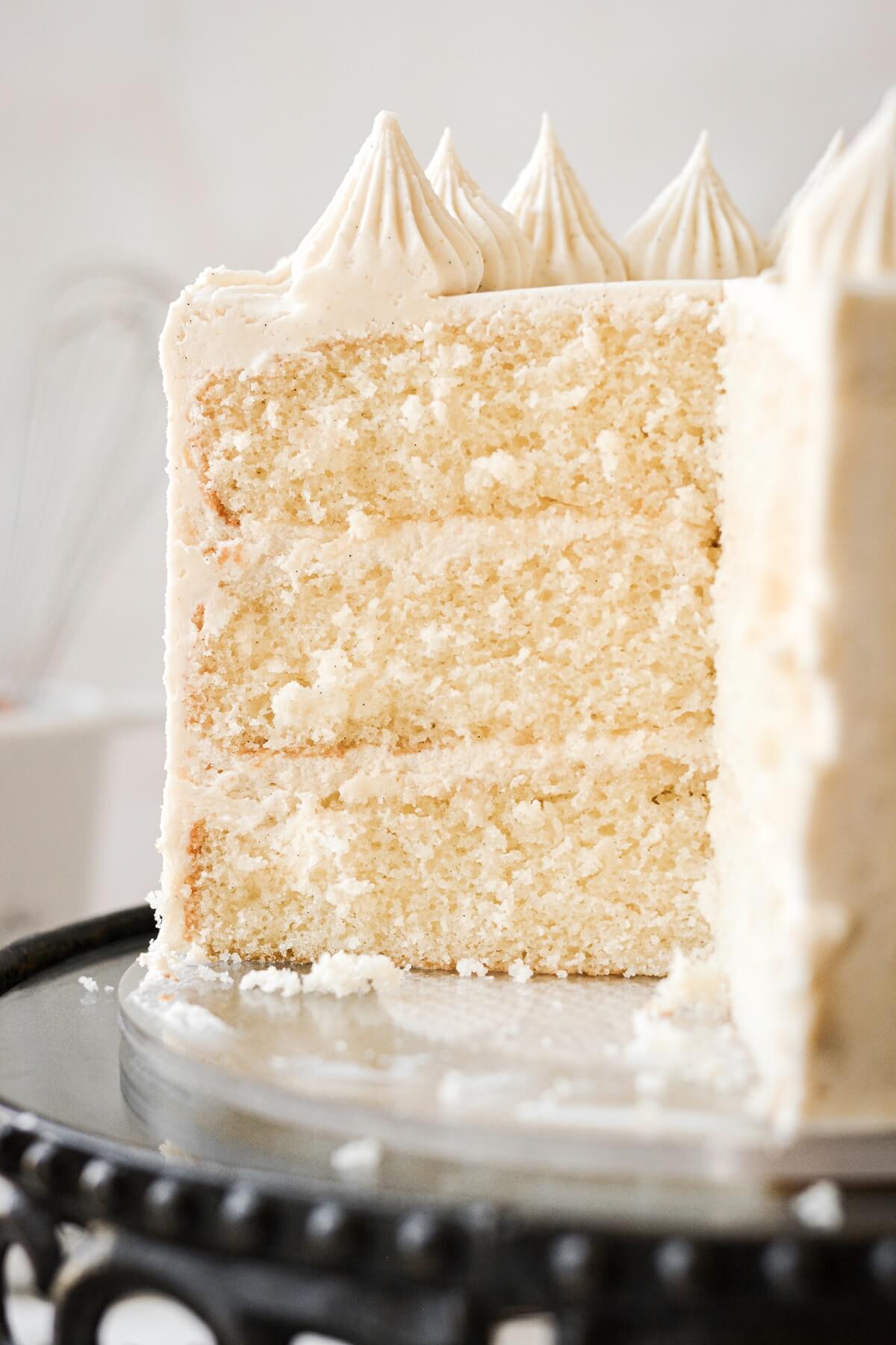 Banana layer cake with a slice cut to show the layers inside.