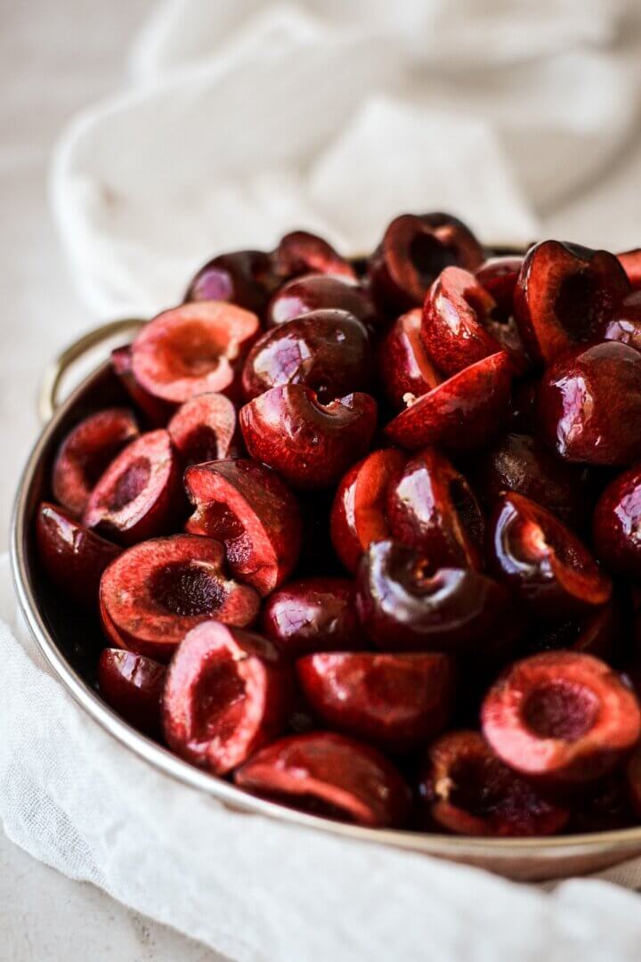 Bowl of cherries cut in half.