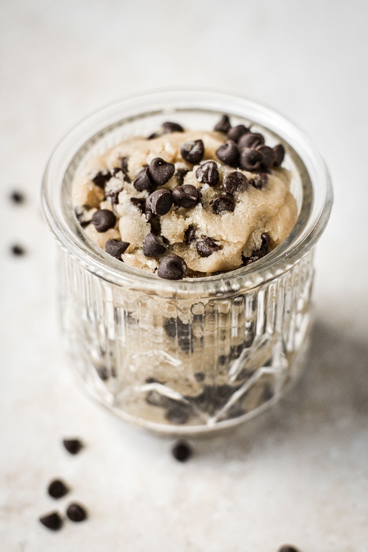 Chocolate chip cookie dough in a glass jar.