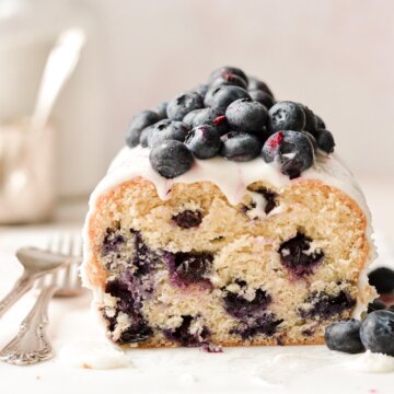 Lemon blueberry loaf cake with a slice cut.