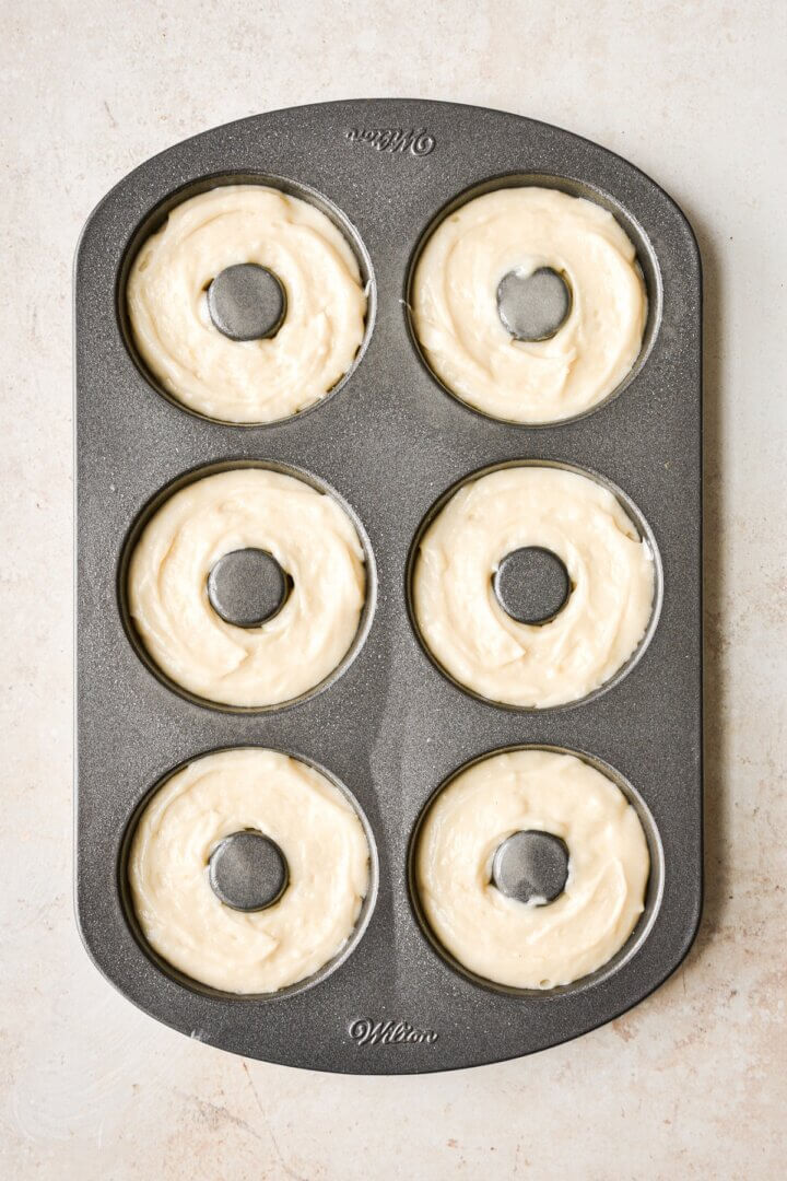 Step 3 for making baked lemon sugar cake doughnuts.