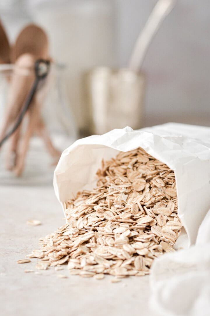 Old fashioned oats spilling out of a bag.