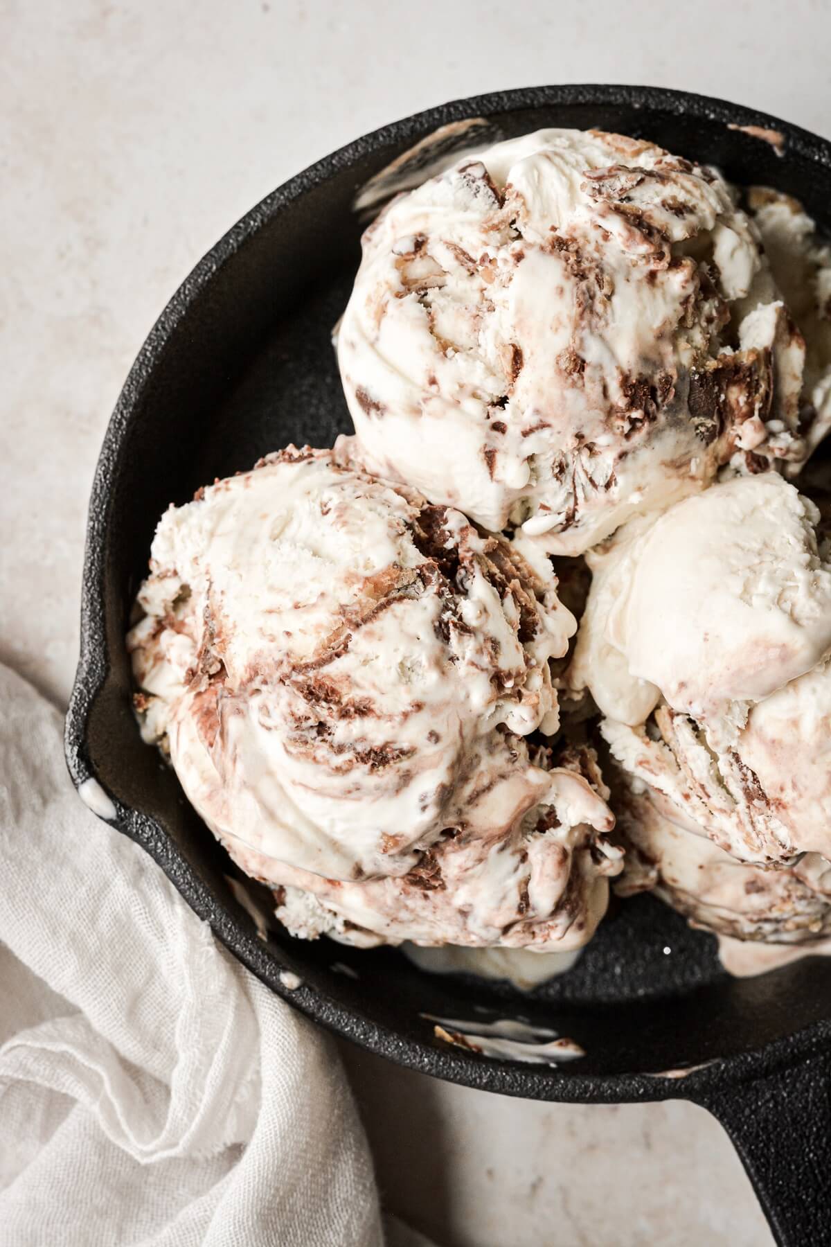 Scoops of no churn peanut butter vanilla fudge ripple ice cream.