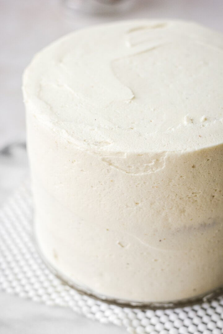 Pistachio coconut cake layers covered in buttercream.