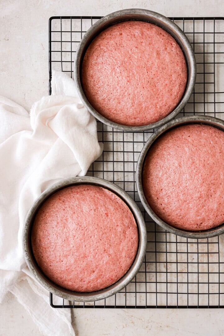 Strawberry cakes on a cooling rack.
