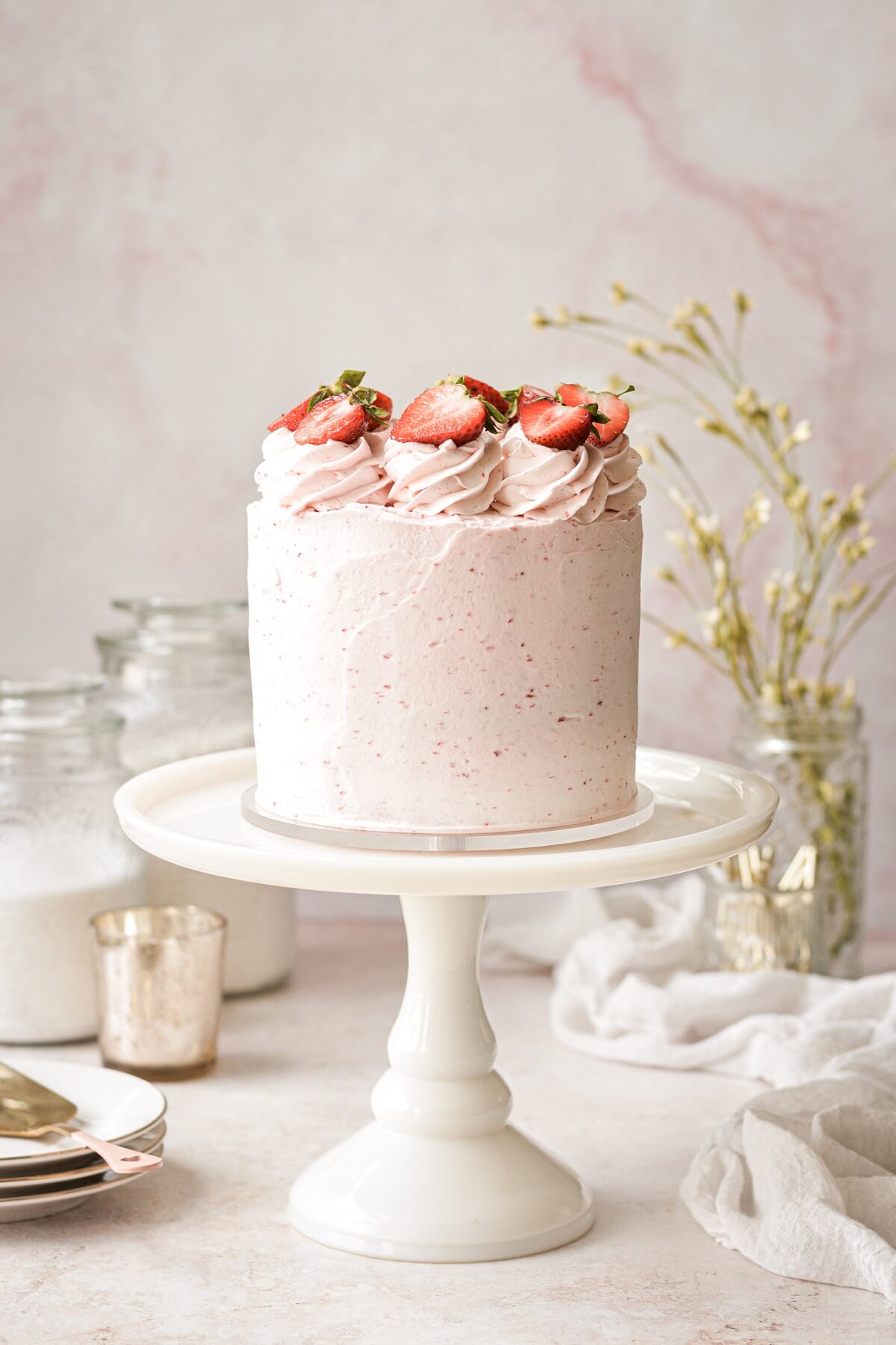 Strawberry cake topped with strawberry slices.