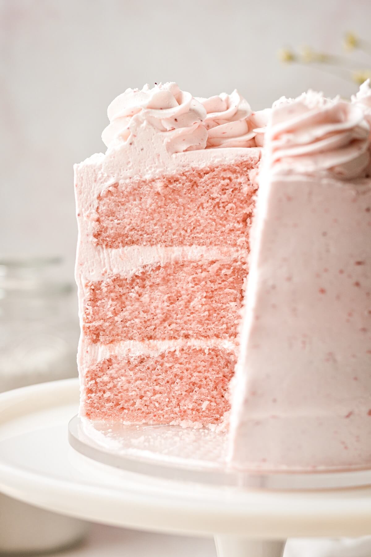 Strawberry cake with a slice cut.