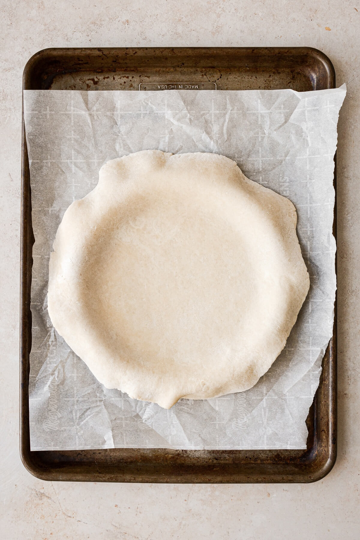 Pie dough on a baking sheet.