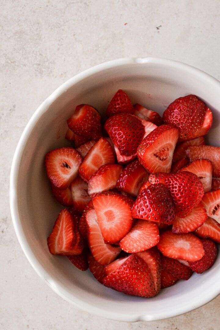 Bowl of sliced strawberries.