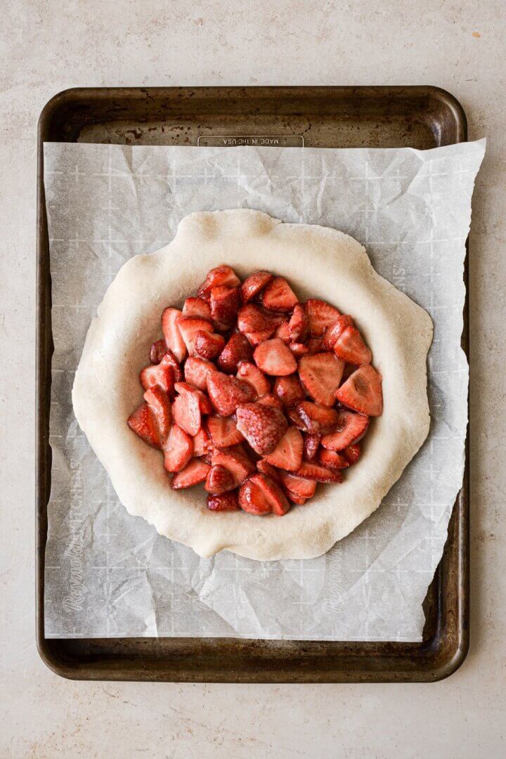 Pie dough filled with strawberries.