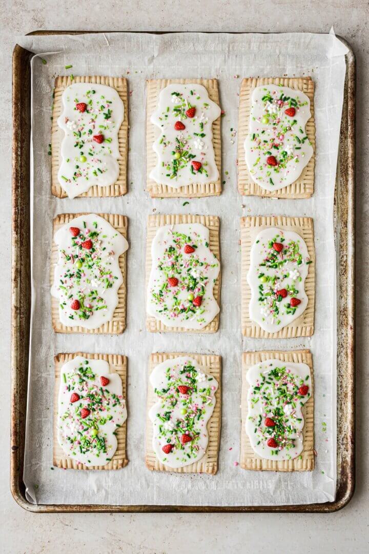 Icing and sprinkles on homemade strawberry pop tarts.