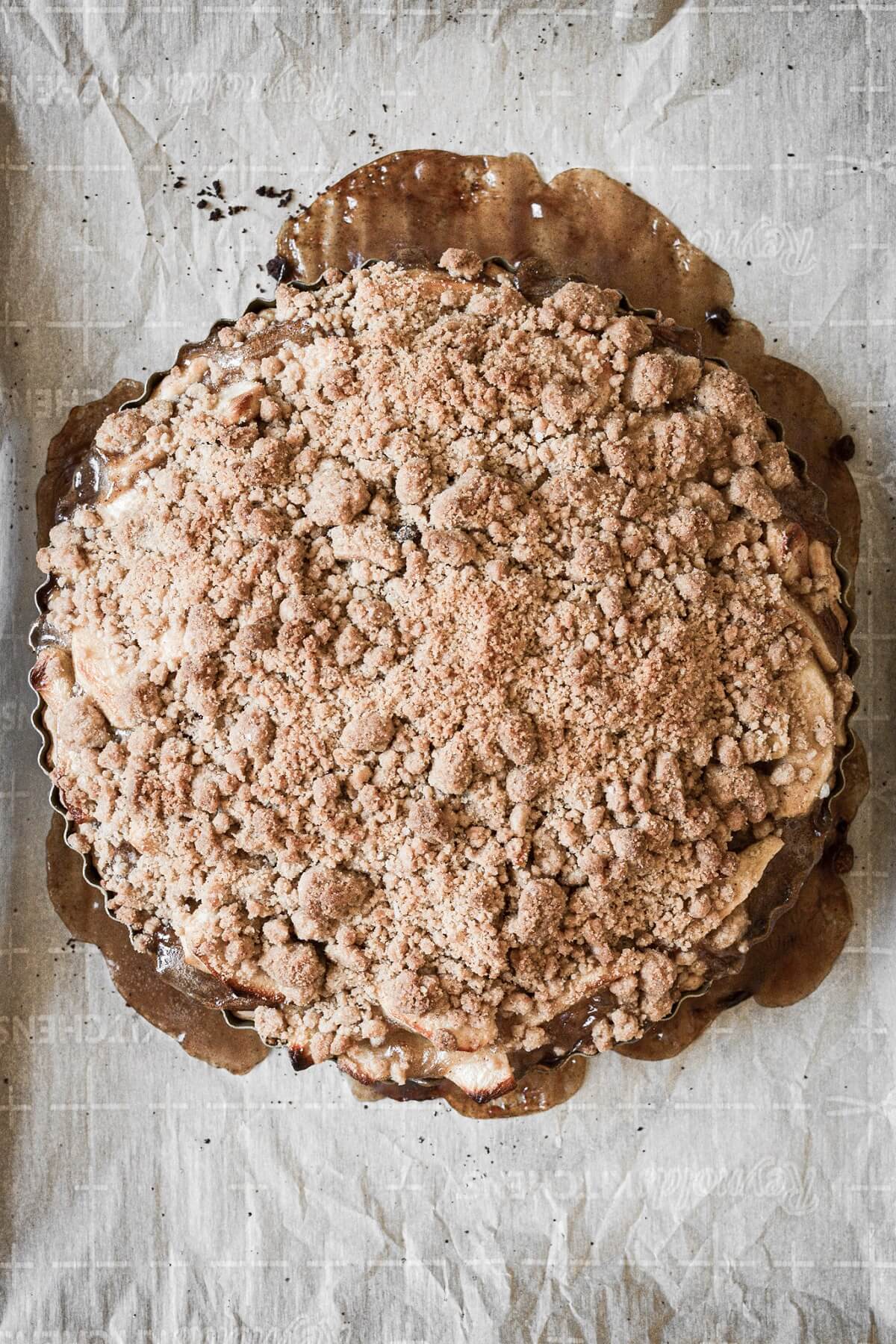 Apple crumb pie on a baking sheet.