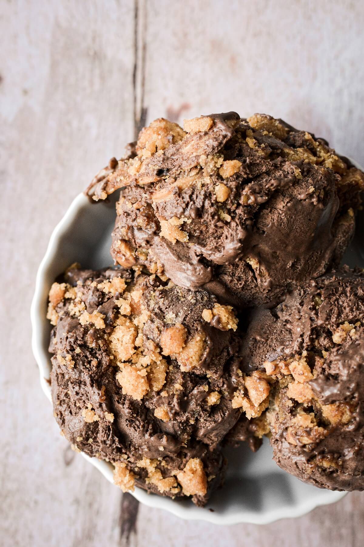 Three scoops of no churn chocolate peanut butter cookie ice cream.