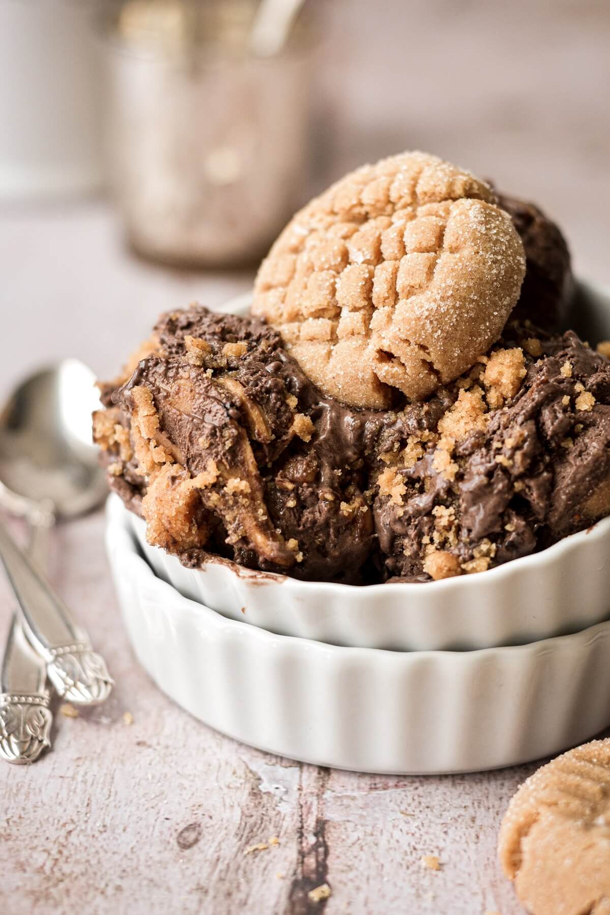Peanut butter cookie sitting on top of no churn chocolate peanut butter cookie ice cream.