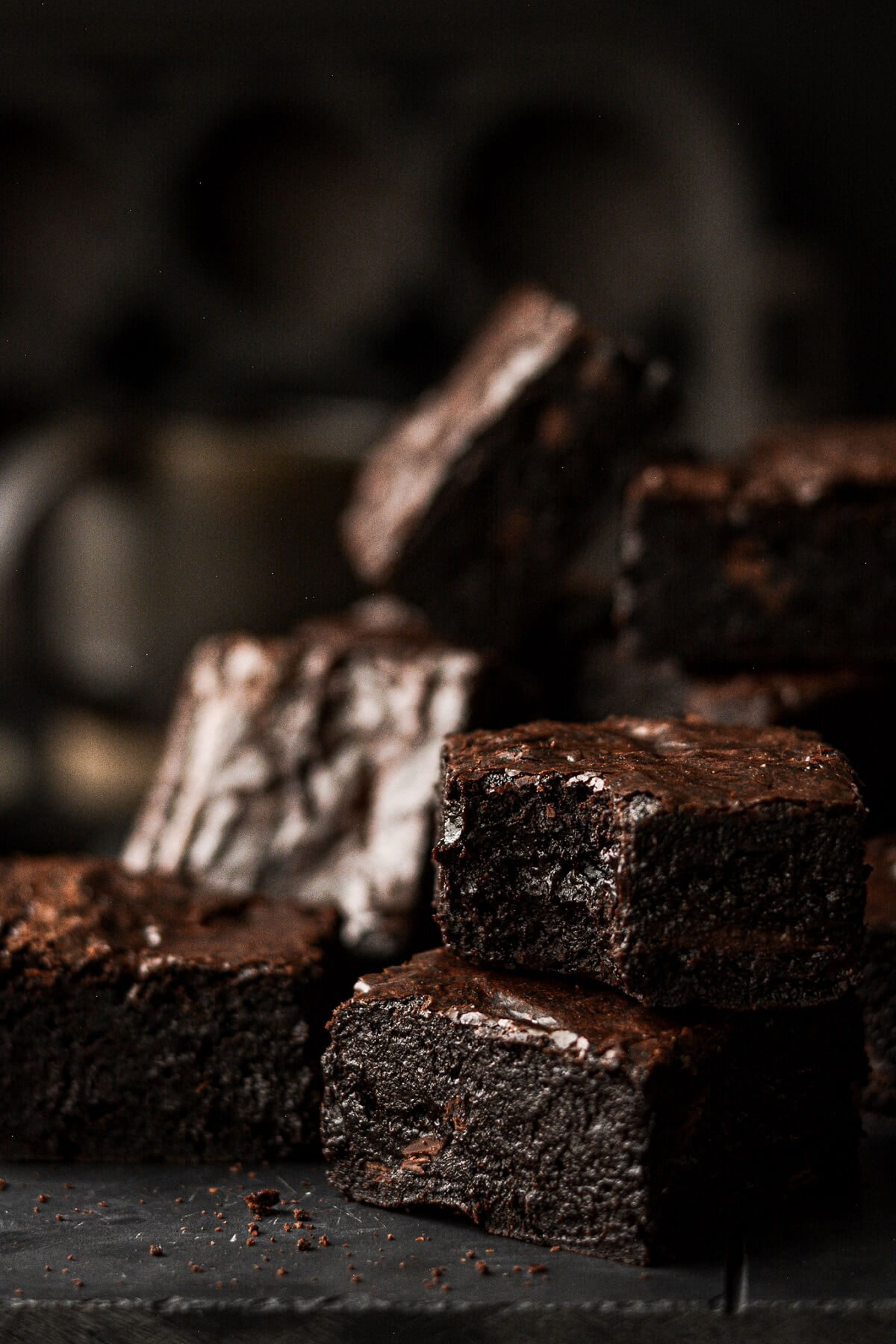 Thick high altitude fudge brownies, one with a bite taken.